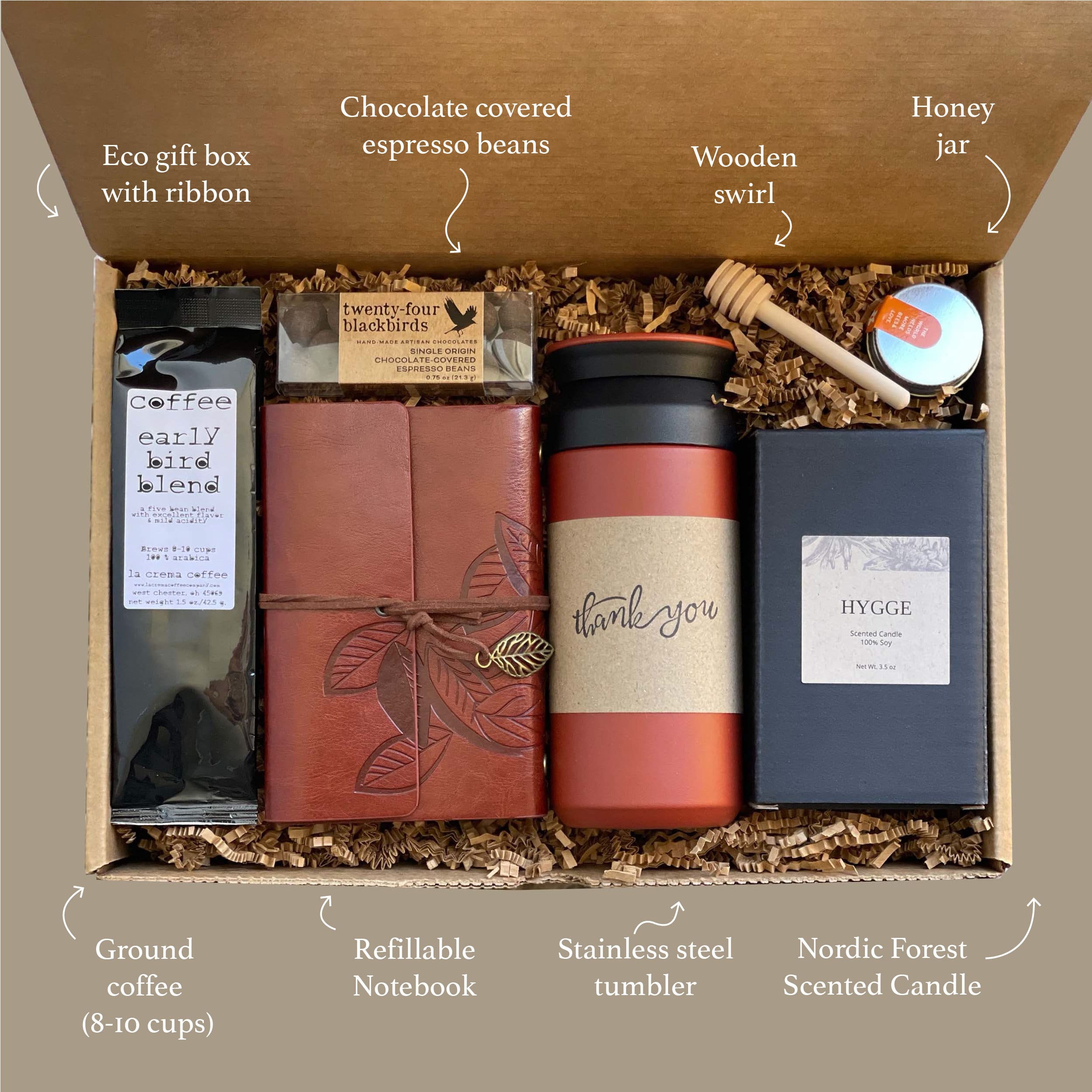 Elegantly packaged corporate gift box with premium items including gourmet treats and branded merchandise, arranged on a clean, minimal background with subtle corporate styling. No human shapes.