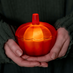 Scented candle in a glass pumpkin-shape jar (harvest scent)